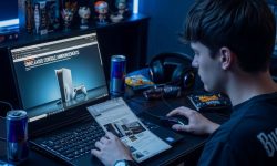 Gaming enthusiast reading Eurogamer Online news on laptop screen showing unreleased console announcements