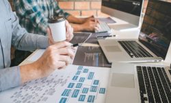 Developer building reliable software systems with code, testing tools, and system architecture diagrams